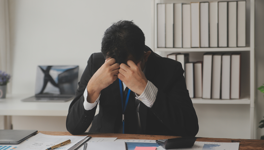 Een jonge, enthousiaste ondernemer die aan een bureau zit en zijn eerste factuur verstuurt.